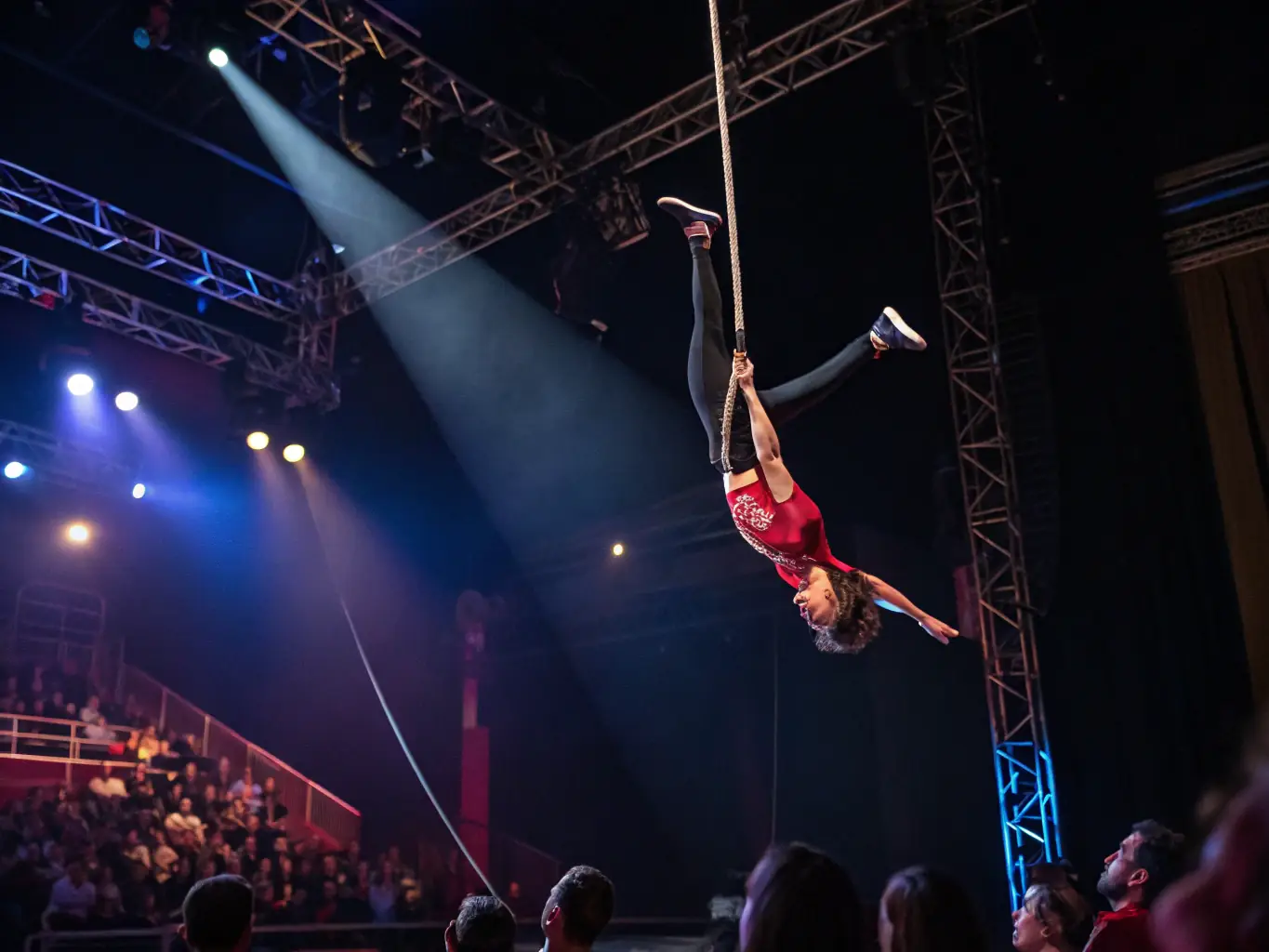 A photo of an advanced acrobat executing a complex aerial silks routine, highlighting the high level of skill achievable at ABE.